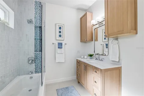 a bathroom with a sink a mirror and a bathtub