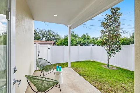 a view of an chair and table in backyard