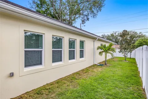 a view of house with backyard space and garden