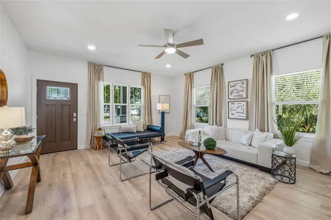 a living room with furniture and wooden floor