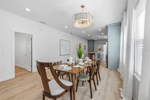 a view of a dining room with furniture window and wooden floor