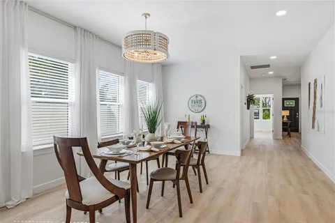 a view of a dining room with furniture and chandelier