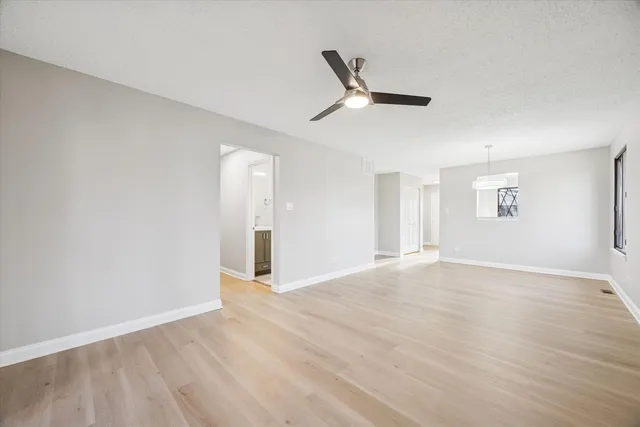 a view of a hallway with a cabinet and a bathroom