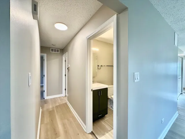 an empty room with a window and a ceiling fan