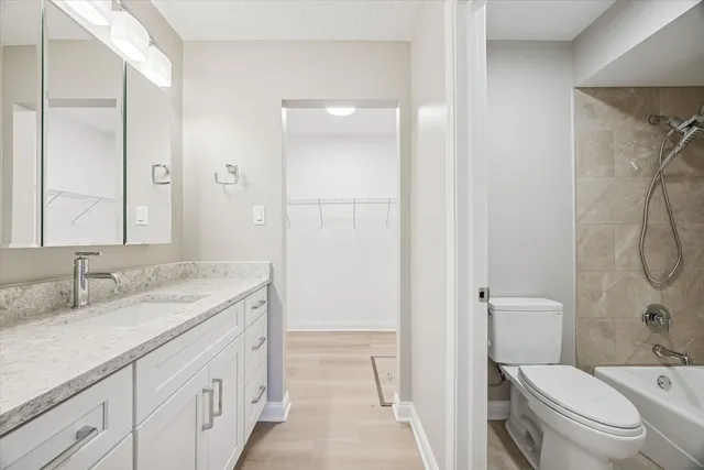 an empty room with an entryway and fan