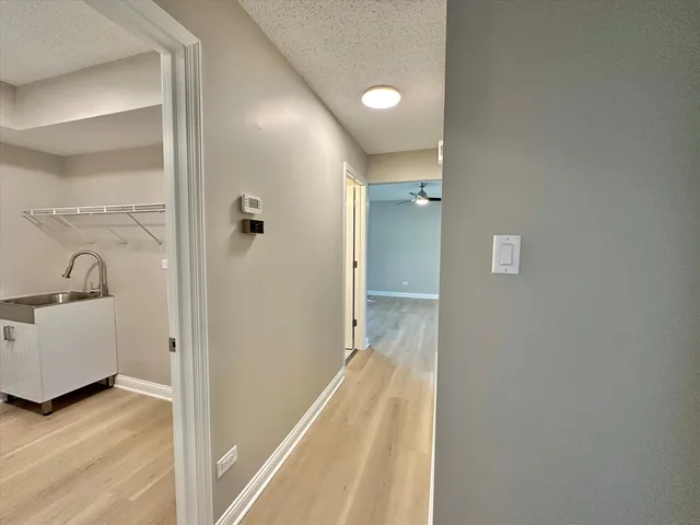 an empty room with a ceiling fan and window