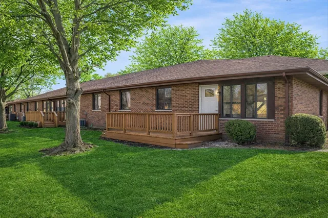 a view of a house with a yard and a porch