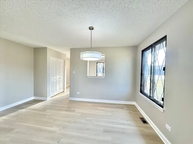 a view of a kitchen with white cabinets