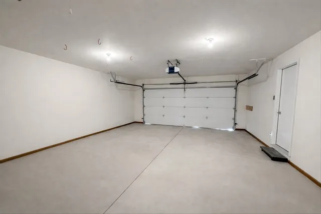 a picture of a room with a white wall and a large window