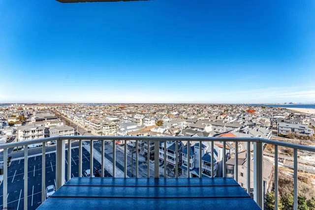 a view of a balcony with wooden floor and city view