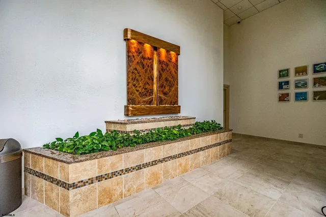 a living room with furniture a flat screen tv and wooden floor