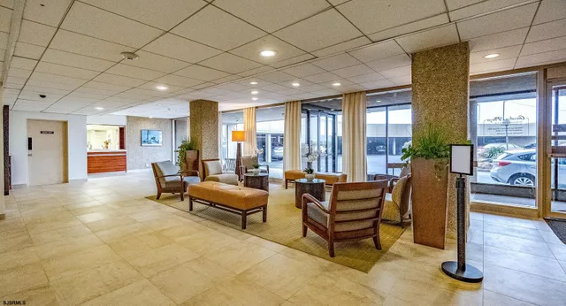 a living room with furniture and a floor to ceiling window