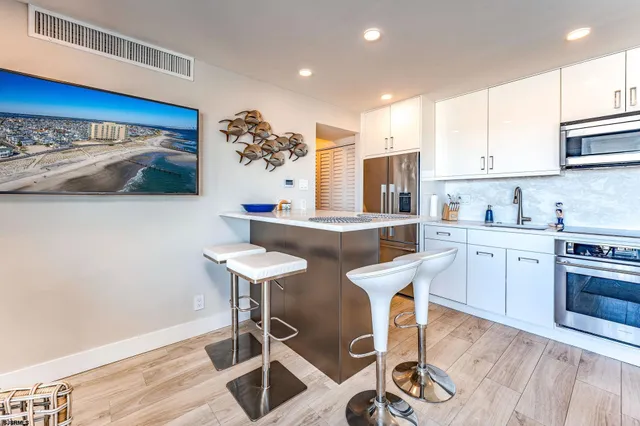 a kitchen with a sink cabinets and wooden floor