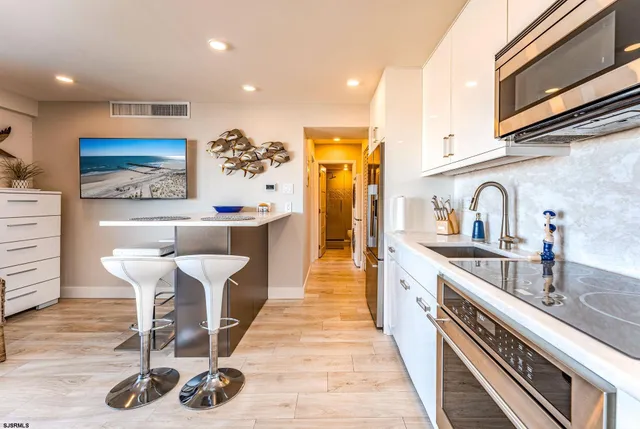 a kitchen with stainless steel appliances a sink and cabinets