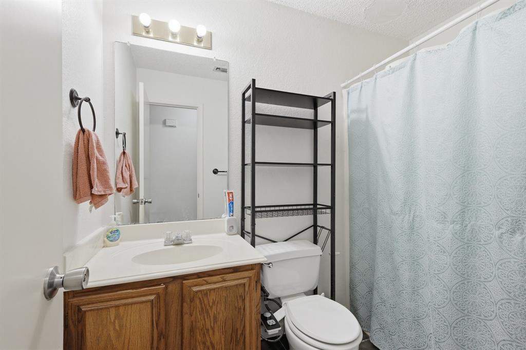4217 Broken Arrow Road Fort Worth, TX 76137 - Photo 30 of 40 a bathroom with a sink toilet and shower