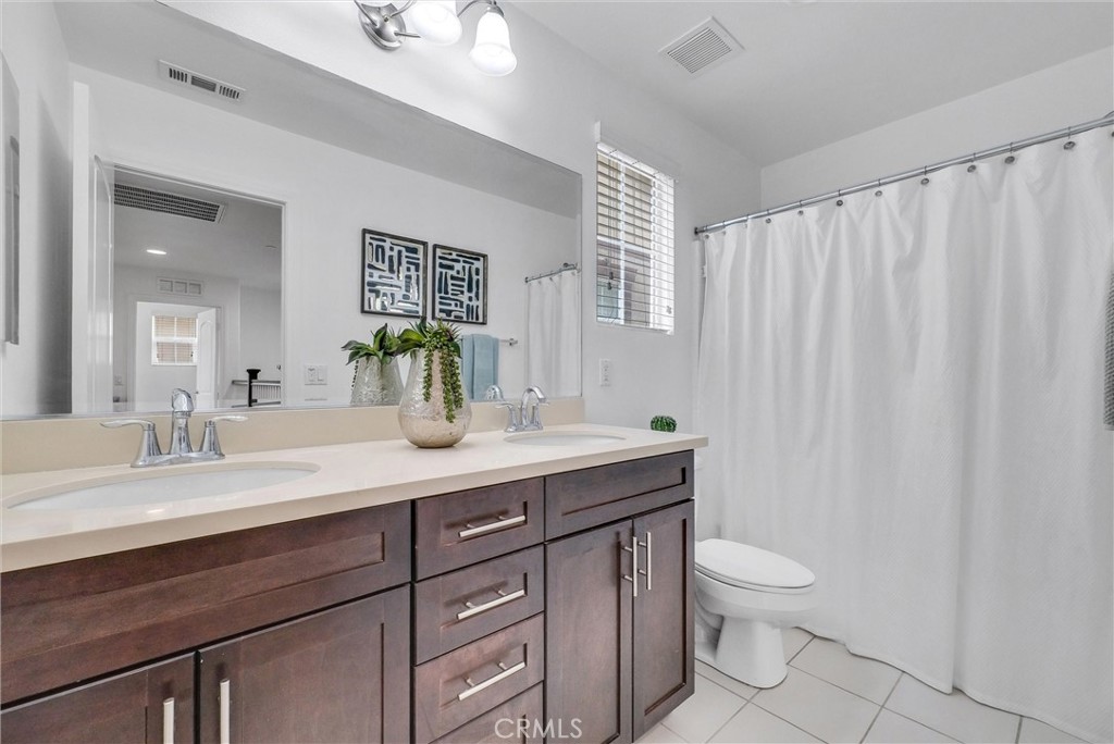719 Huron Place Claremont, CA 91711 - Photo 20 of 37 a bathroom with a granite countertop sink a toilet and a mirror