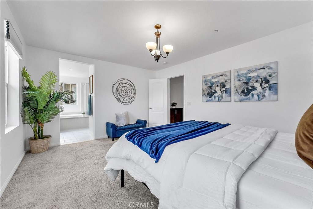 719 Huron Place Claremont, CA 91711 - Photo 22 of 37 a bedroom with bed and a chandelier