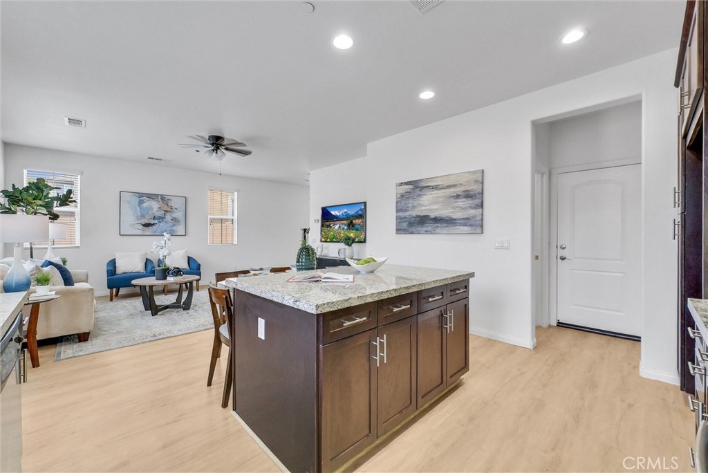 719 Huron Place Claremont, CA 91711 - Photo 7 of 37 a kitchen that has a lot of cabinets a sink and a wooden floor