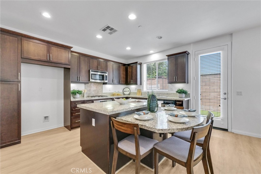 719 Huron Place Claremont, CA 91711 - Photo 9 of 37 a kitchen with a dining table cabinets and stainless steel appliances