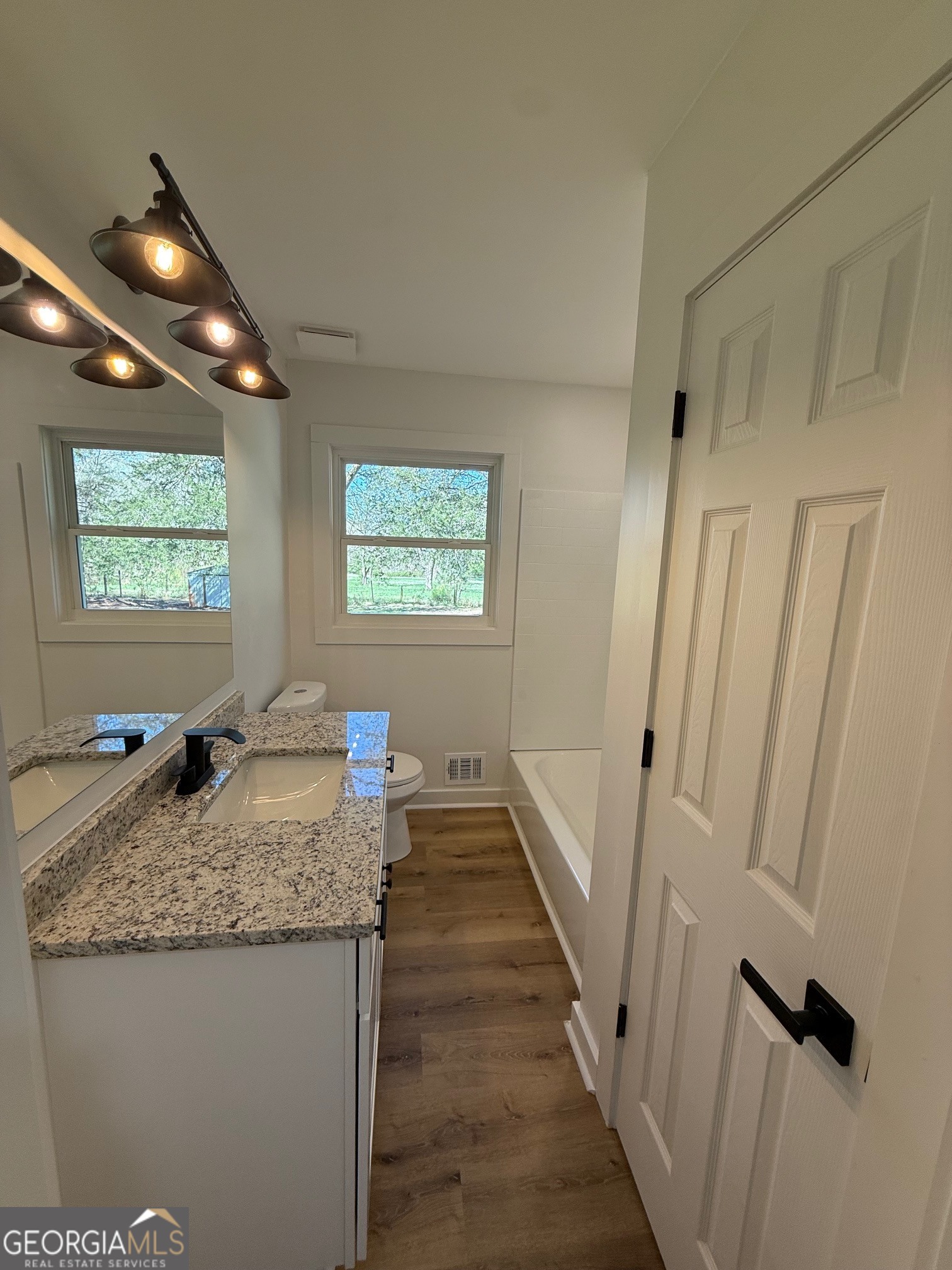 4005 Highway 85 Manchester, GA 31816 - Photo 16 of 41 a hallway with granite countertop a sink and a granite counter top