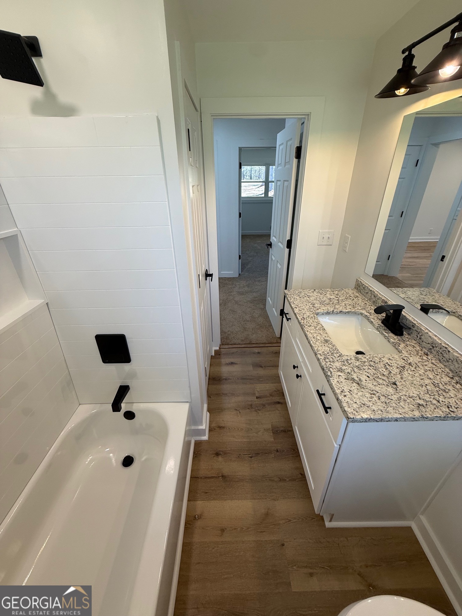4005 Highway 85 Manchester, GA 31816 - Photo 18 of 41 a bathroom with a granite countertop sink a mirror and shower