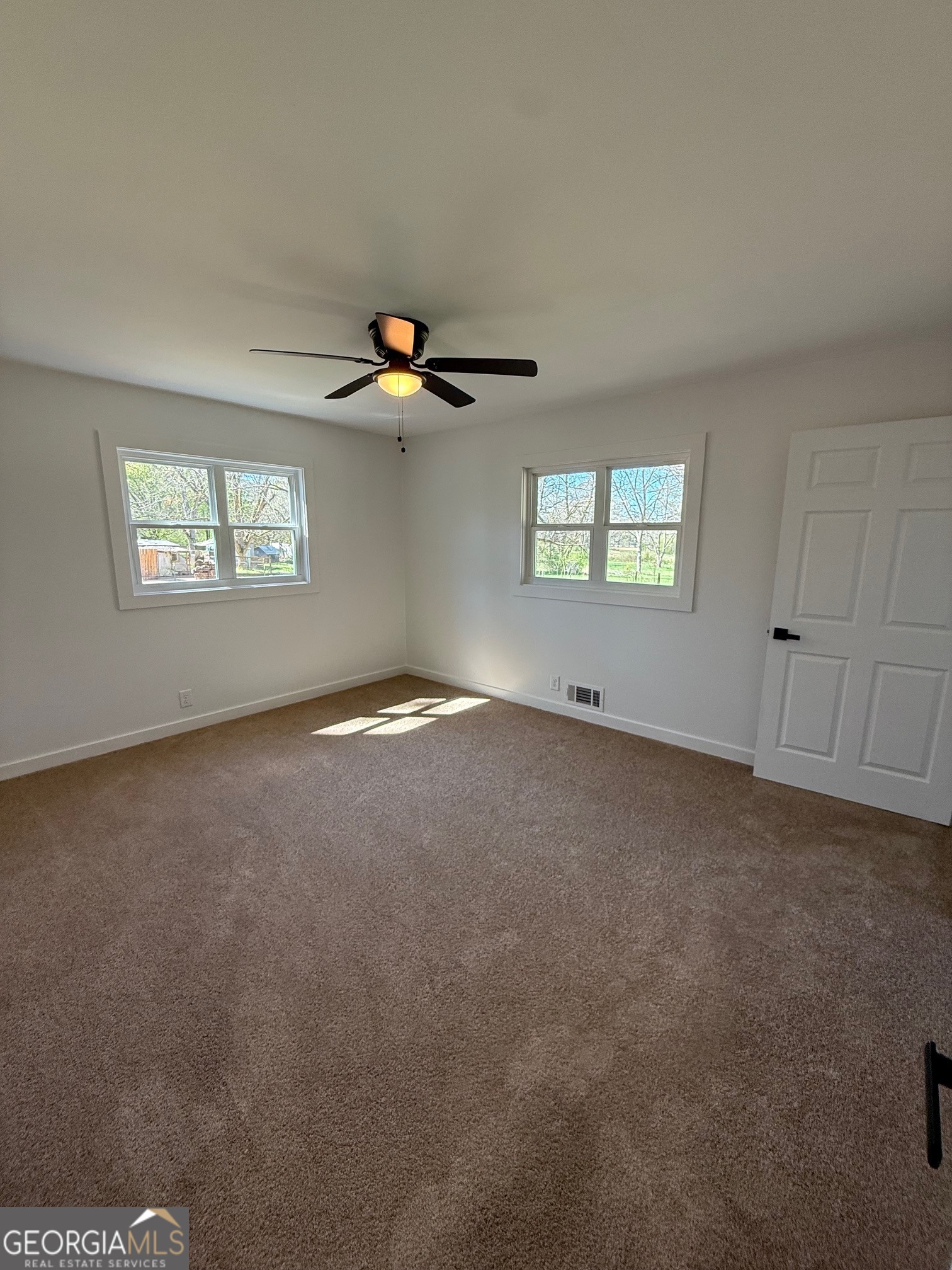 4005 Highway 85 Manchester, GA 31816 - Photo 23 of 41 an empty room with windows and ceiling fan