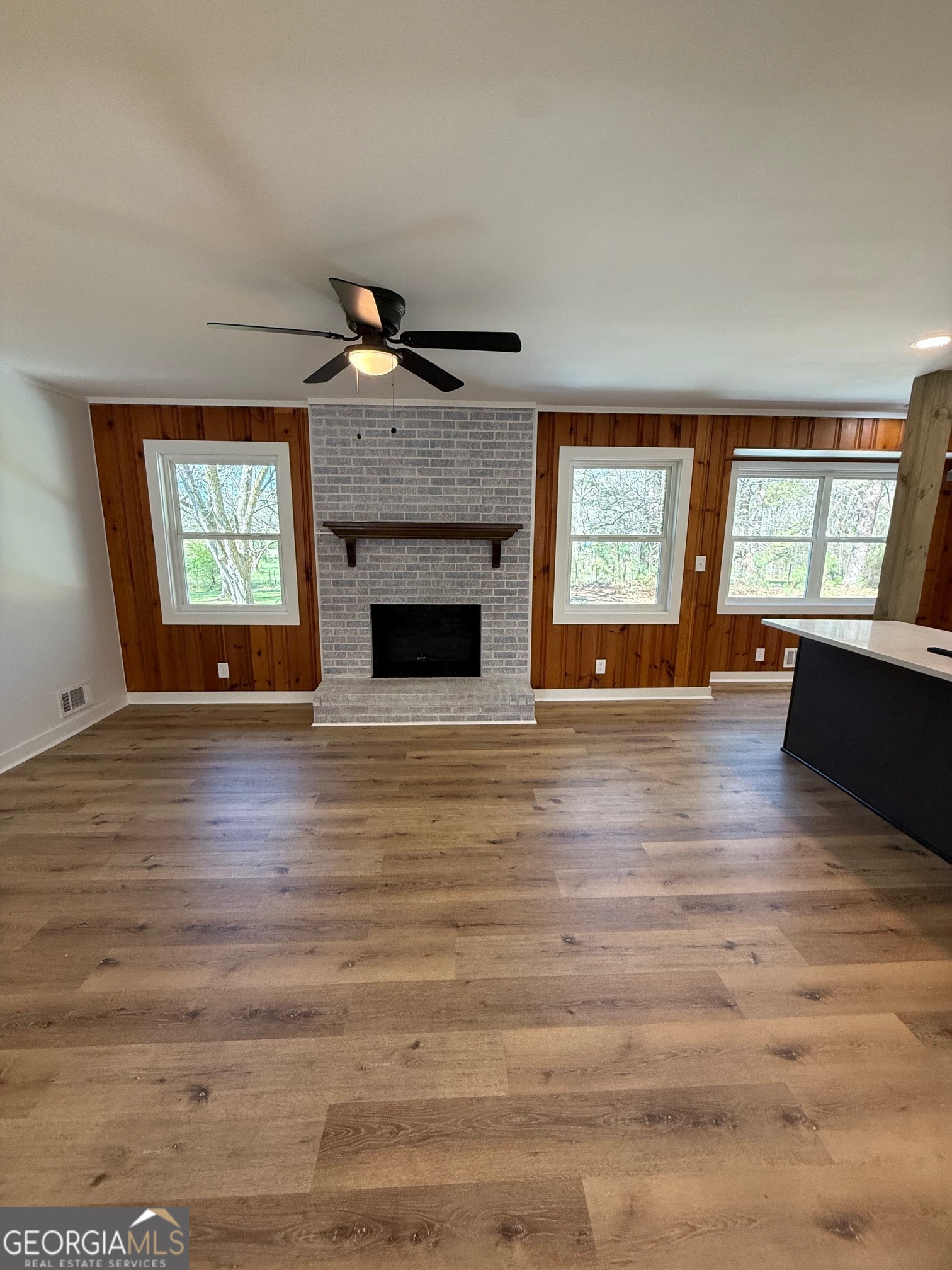 4005 Highway 85 Manchester, GA 31816 - Photo 10 of 41 a view of an empty room with wooden floor fireplace and a window
