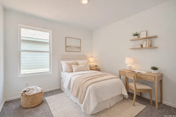 a bedroom with a bed and a window