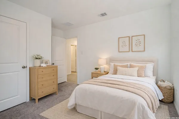 a bedroom with a bad and dresser