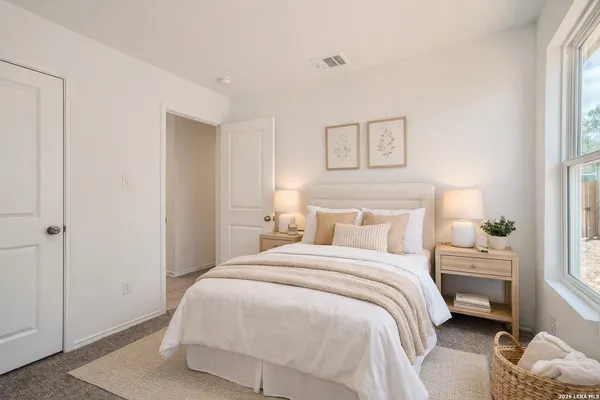 a bedroom with a bed and a window