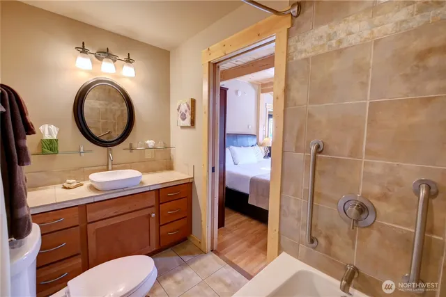 a bathroom with a toilet a sink and mirror