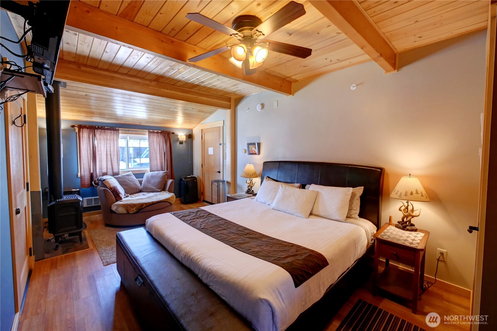 115 Johnson Street, Unit 1 2 3 Twisp, WA 98856 - Photo 14 of 40 a bedroom with bed and a chandelier