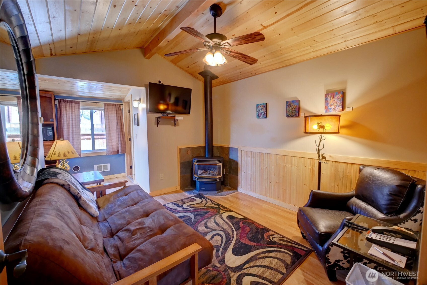 115 Johnson Street, Unit 1 2 3 Twisp, WA 98856 - Photo 22 of 40 a living room with furniture and a flat screen tv