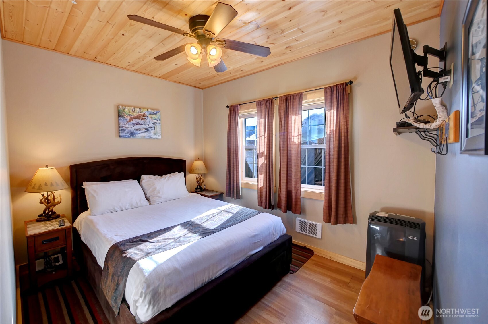 115 Johnson Street, Unit 1 2 3 Twisp, WA 98856 - Photo 23 of 40 a bedroom with a bed and a chandelier