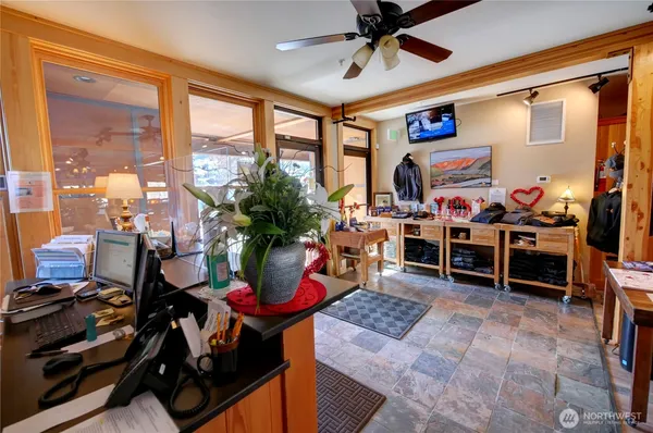 a room with lots of wooden furniture and a large window