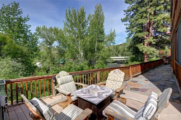 a view of balcony with wooden floor and outdoor seating