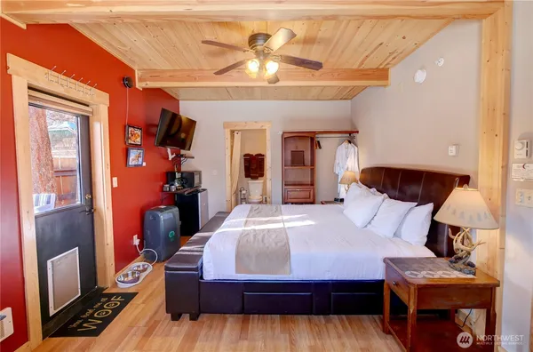 a bedroom with a large bed and a chandelier