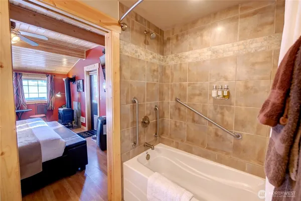 a bathroom with a bathtub and a shower