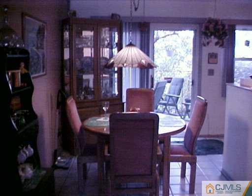 199 Evergreen Road, Unit 12A Edison, NJ 08837 - Photo 6 of 7 a view of a dining room with furniture and chandelier