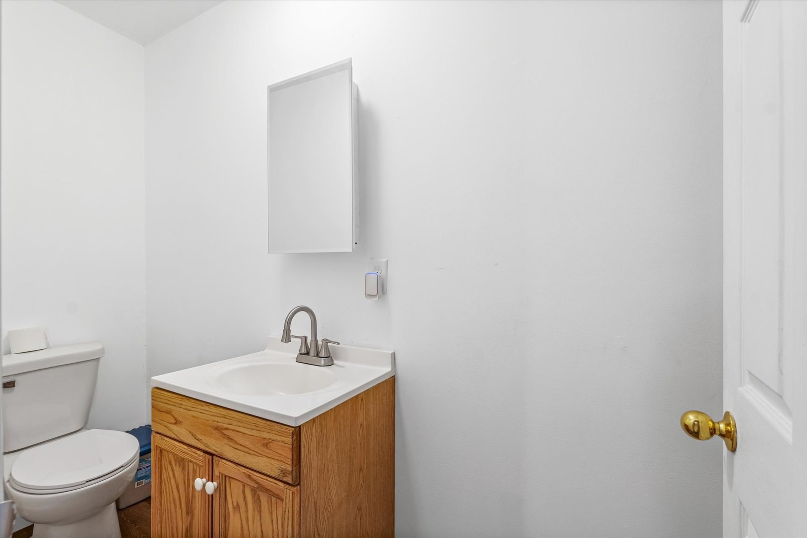 108 Maple Street Roberts, IL 60962 - Photo 15 of 28 a bathroom with a toilet sink and mirror