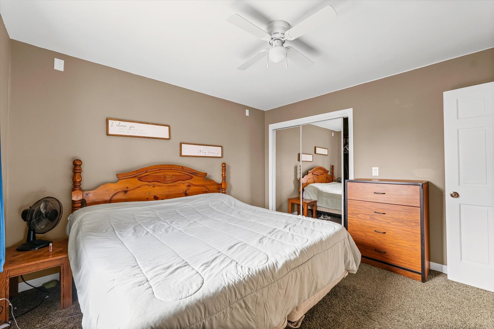 108 Maple Street Roberts, IL 60962 - Photo 16 of 28 a bedroom with a bed and a chandelier