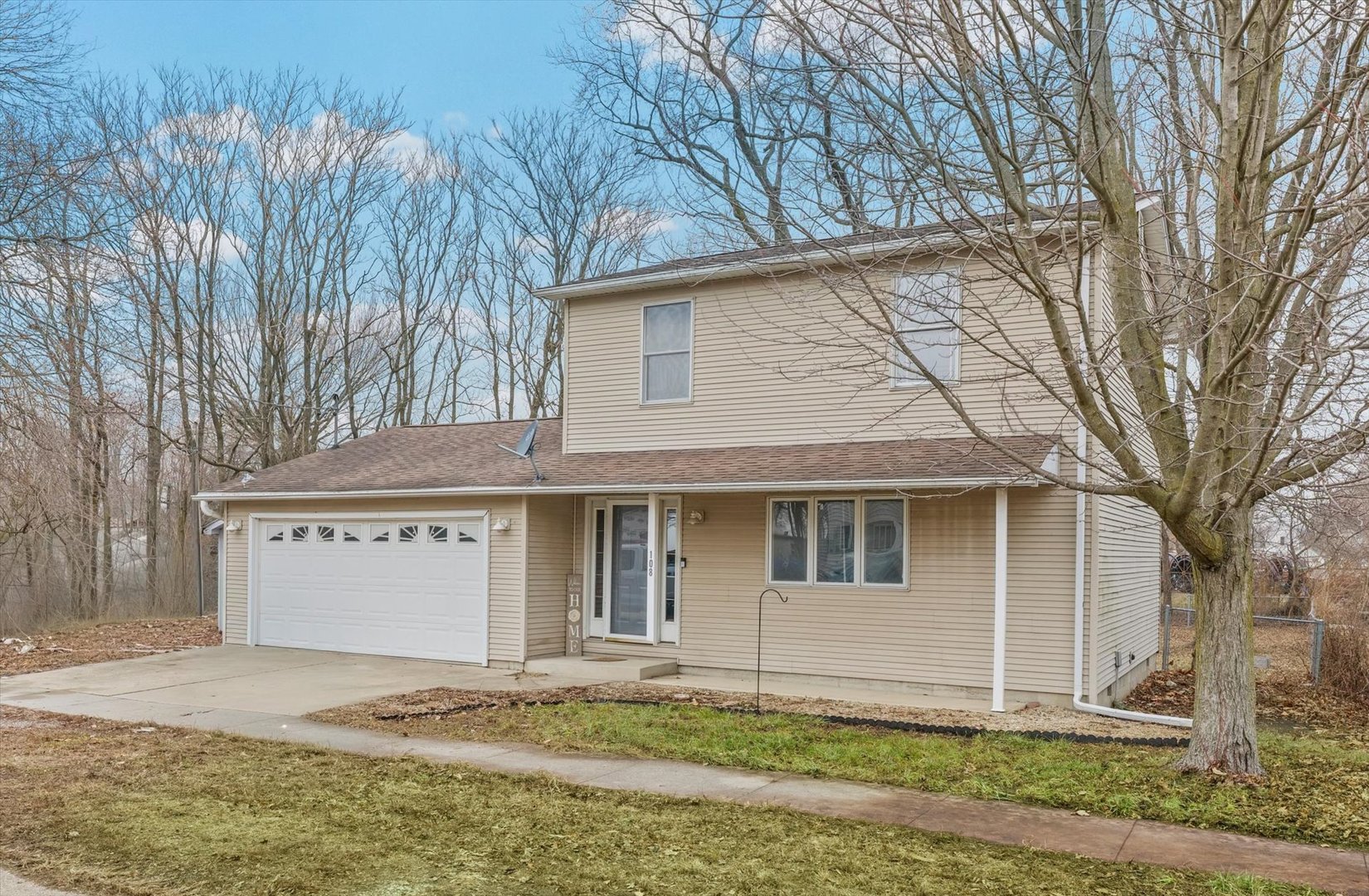 108 Maple Street Roberts, IL 60962 - Photo 2 of 28 a front view of a house with a garden and tree