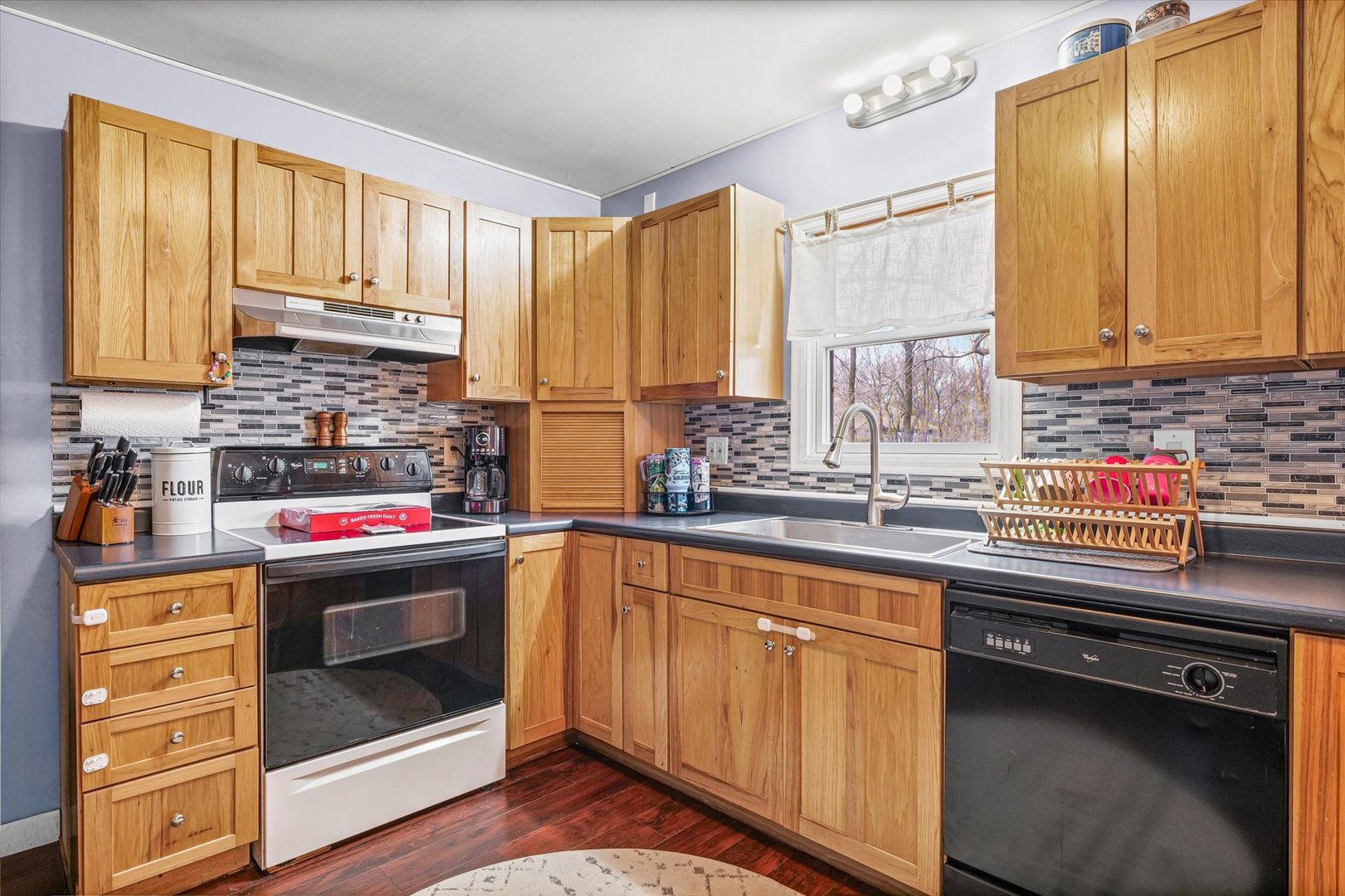 108 Maple Street Roberts, IL 60962 - Photo 10 of 28 a kitchen with stainless steel appliances a stove sink and cabinets
