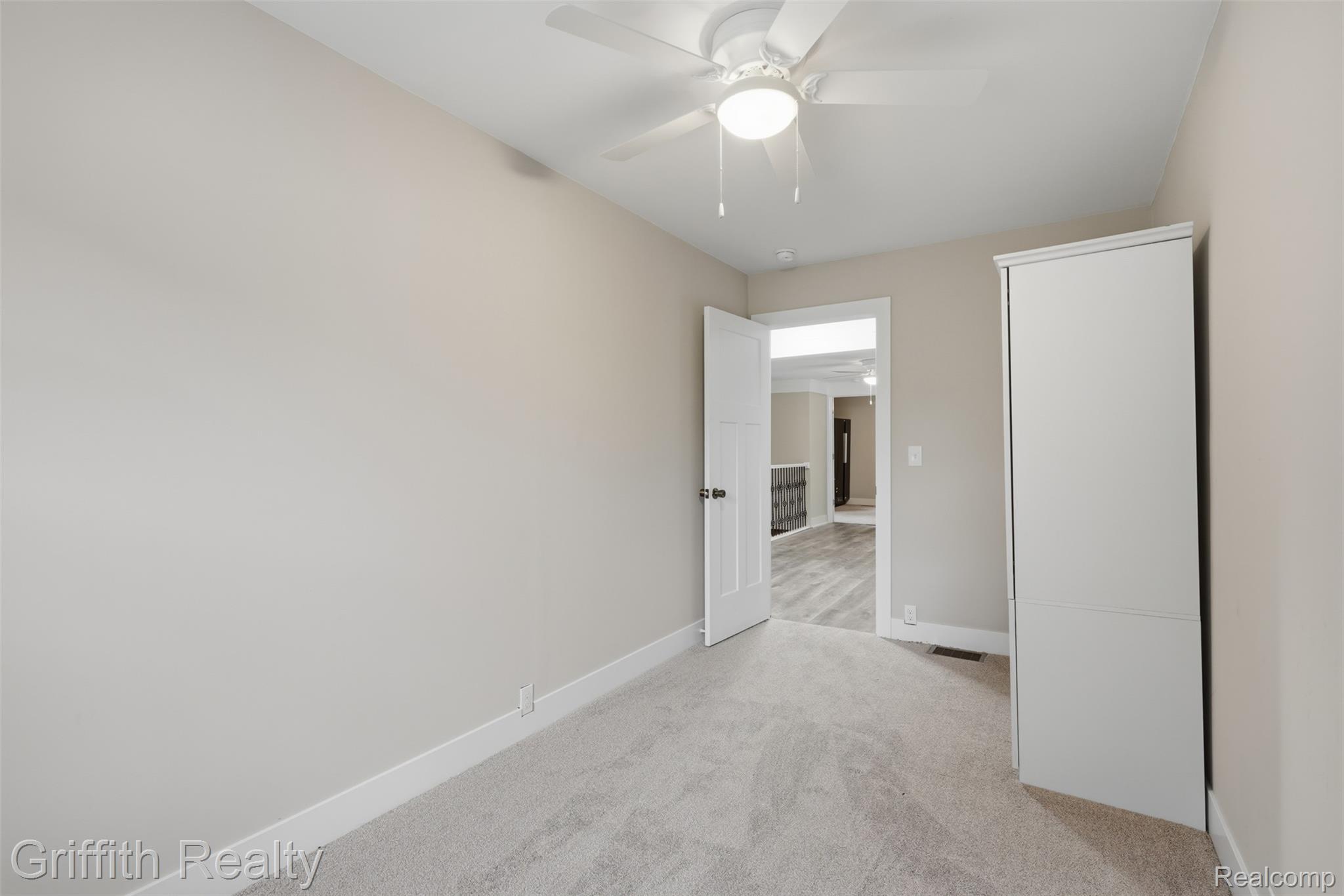 5820 Mack Road Howell, MI 48855 - Photo 24 of 60 Plush carpeting, neutral wall tones, and a ceiling fan with integrated lighting