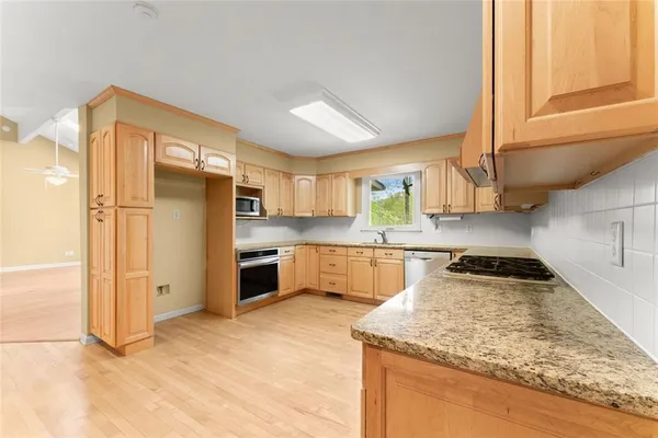 a view of a kitchen with a stove cabinets and a kitchen
