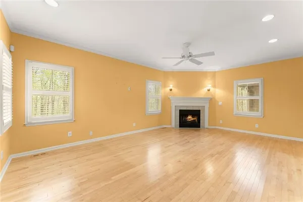a view of an empty room with a fireplace and a window