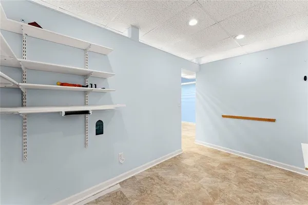 a view of an empty room with a fireplace and a window