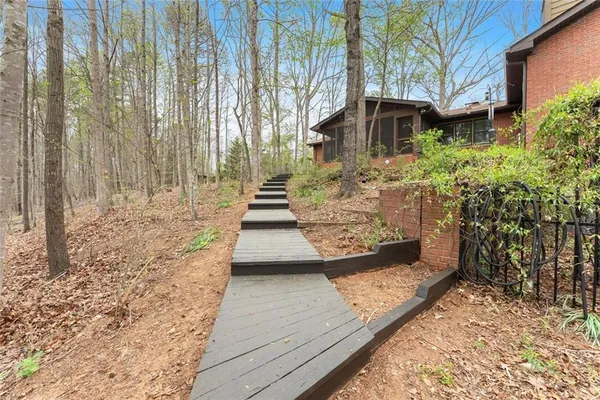 a backyard of a house with lots of green space and two plants