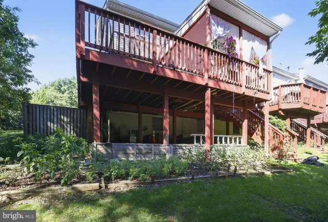 a view of a house with a yard and deck