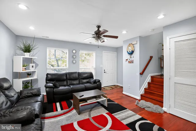 a living room with furniture and wooden floor